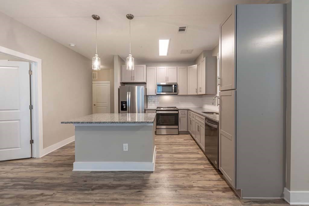 A kitchen with a granite countertop and stainless steel appliances at Foxwood Apartments, Raleigh-Durham, North Carolina