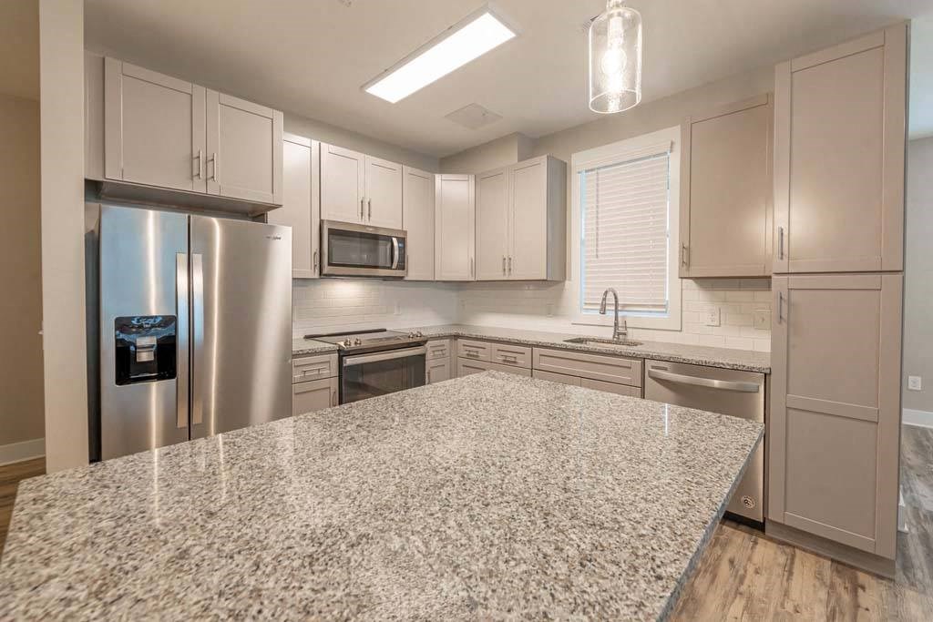 A kitchen with a granite countertop and stainless steel appliances at Foxwood Apartments, North Carolina
