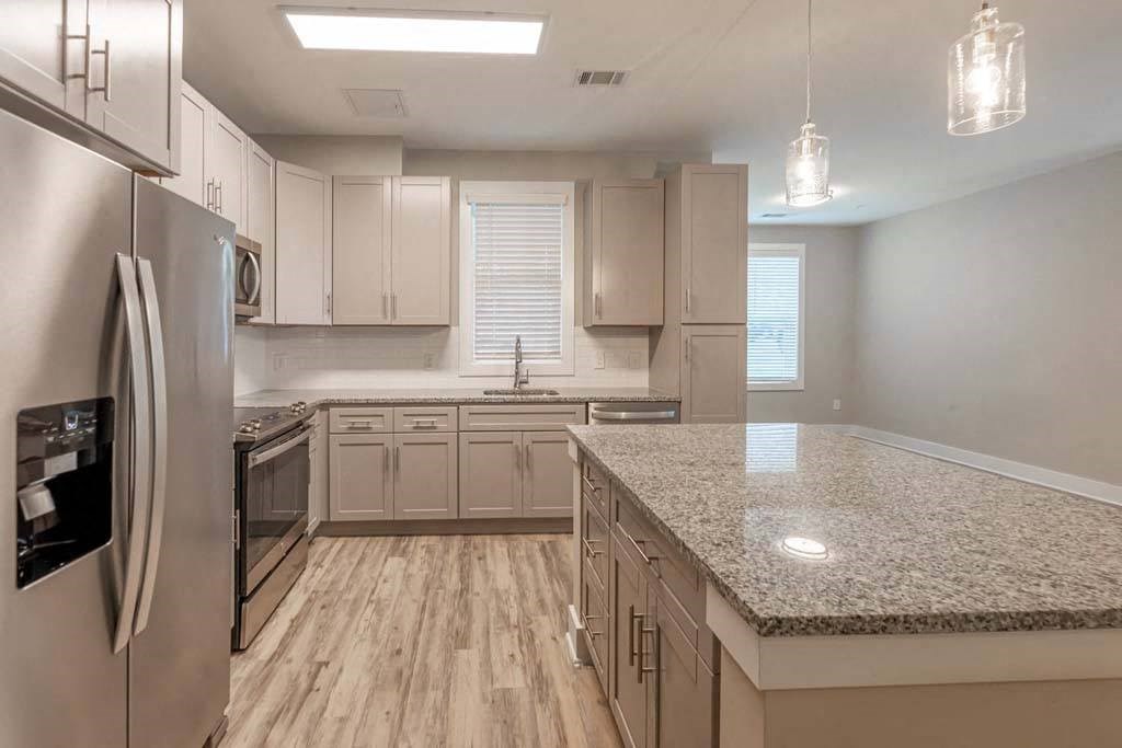 A kitchen with a granite countertop and stainless steel appliances at Foxwood Apartments, Raleigh-Durham, North Carolina