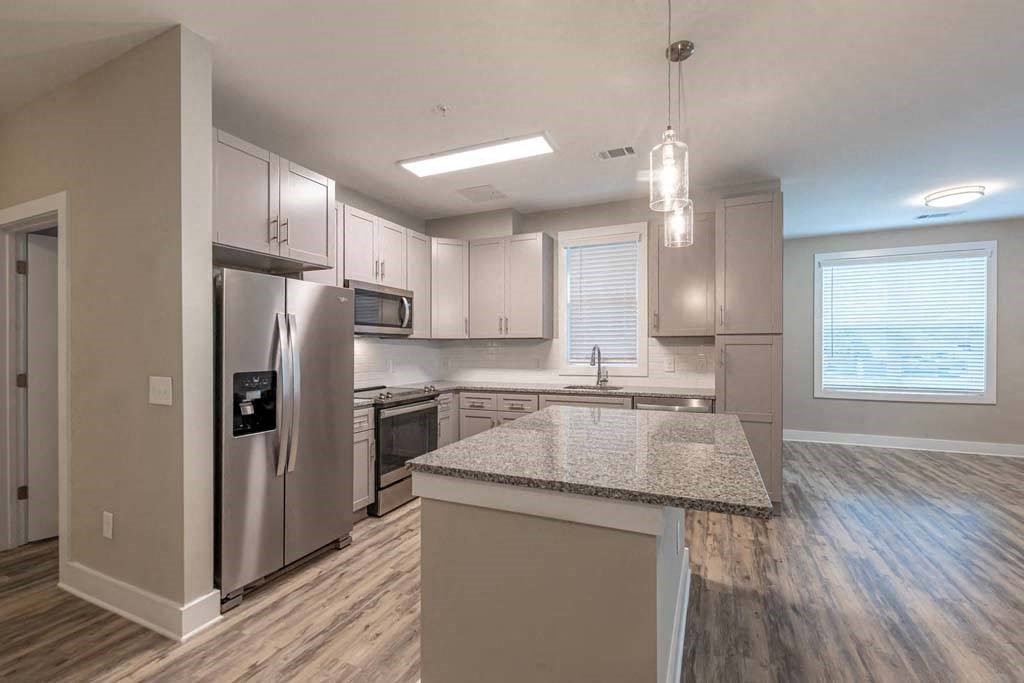 A kitchen with a granite countertop and stainless steel appliances at Foxwood Apartments, Raleigh-Durham