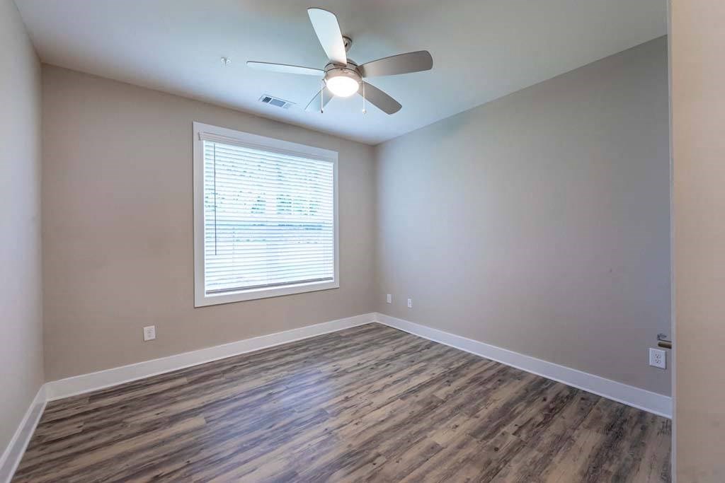 A room with a ceiling fan and a window with blinds at Foxwood Apartments, Raleigh-Durham, 27616