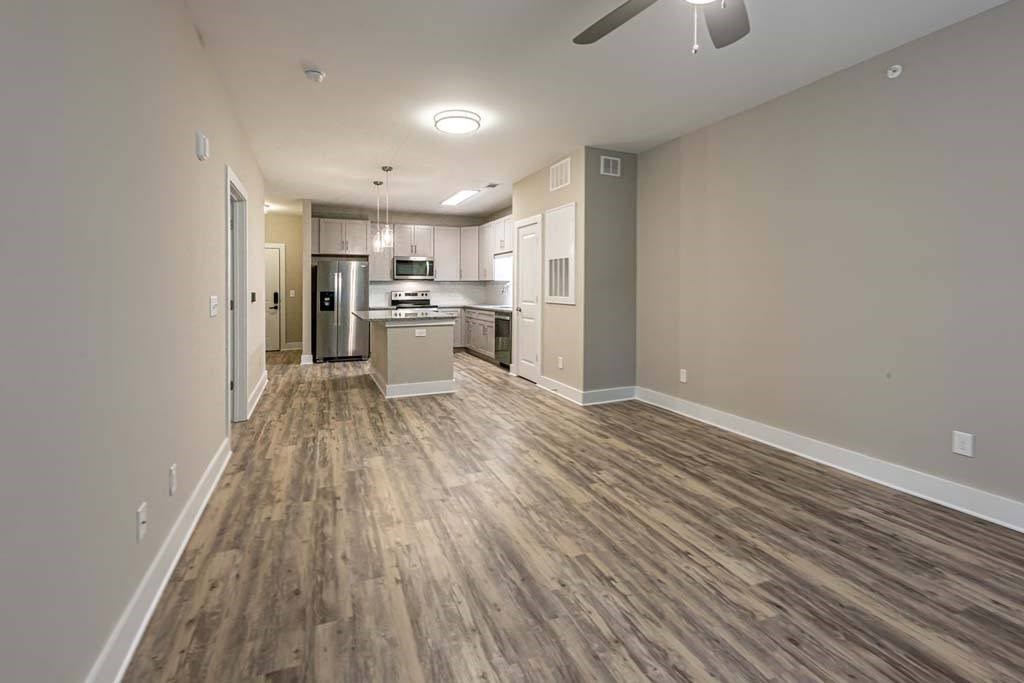 A kitchen area with a refrigerator, microwave, and oven at Foxwood Apartments, Raleigh-Durham, North Carolina