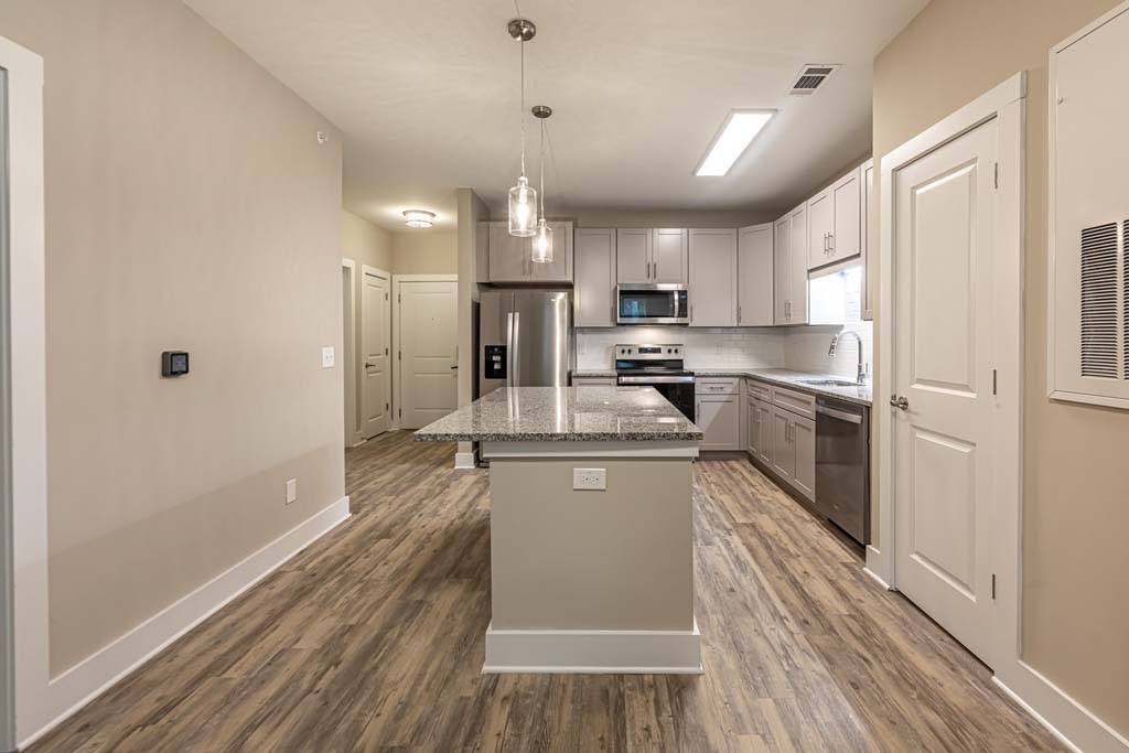 A kitchen with a center island and a microwave above it at Foxwood Apartments, Raleigh-Durham, 27616