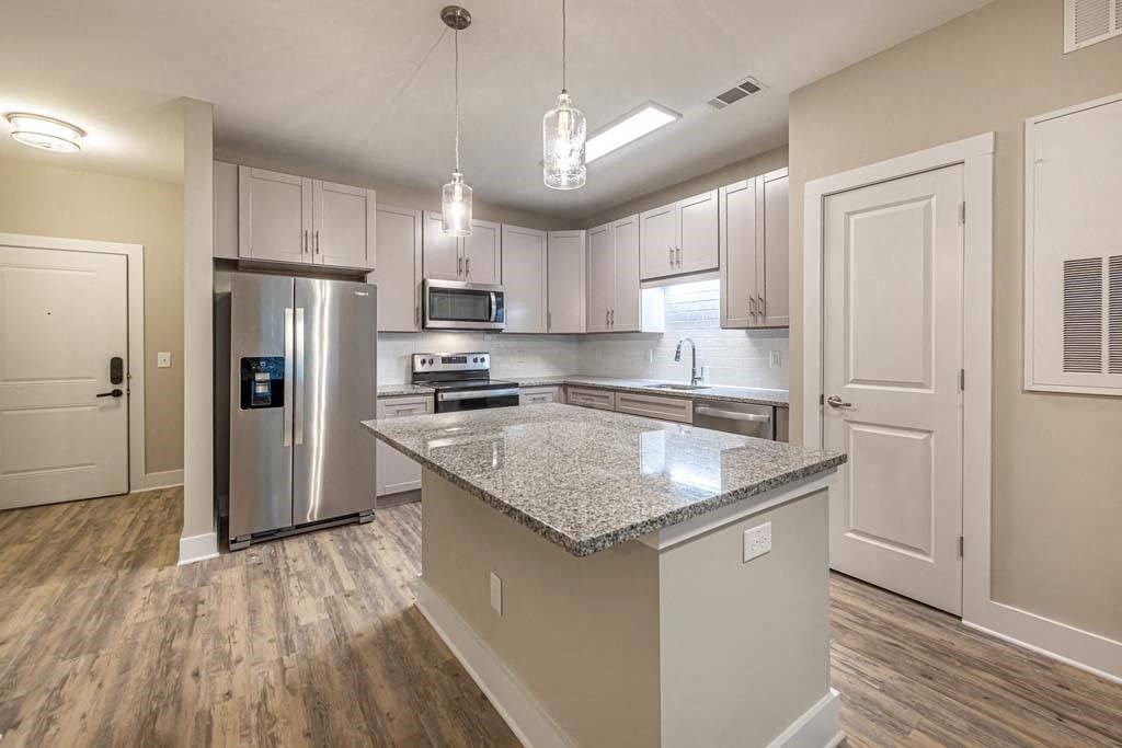 A kitchen with a granite countertop and stainless steel appliances at Foxwood Apartments, North Carolina, 27616