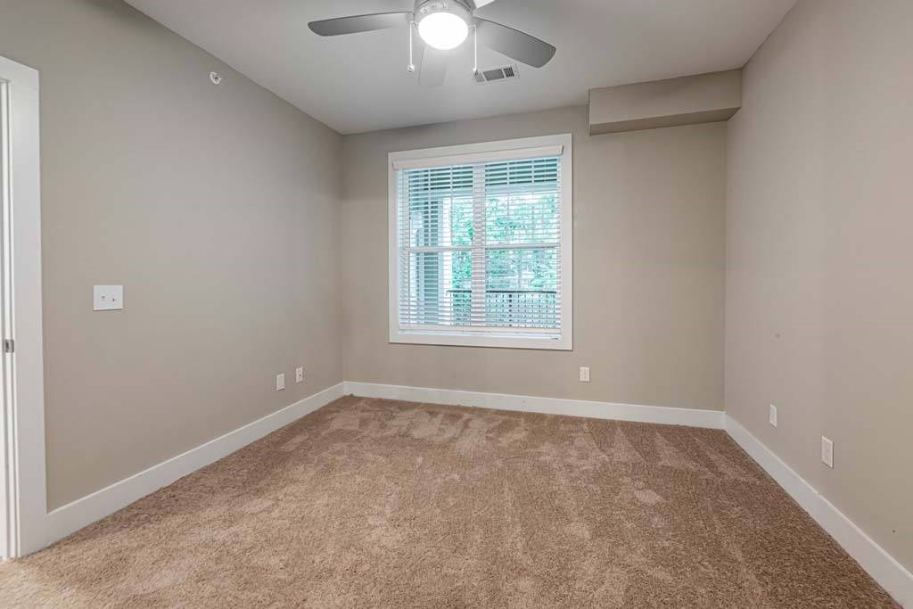 A room with a carpeted floor and a ceiling fan at Foxwood Apartments, Raleigh-Durham, NC, 27616