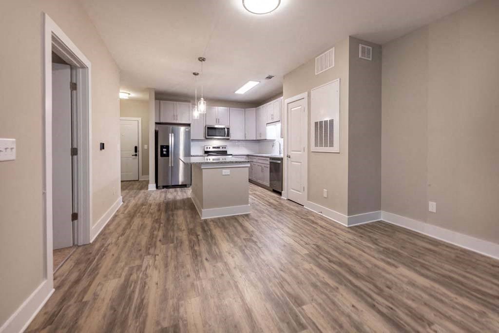 A kitchen with a refrigerator, microwave, and oven at Foxwood Apartments, North Carolina