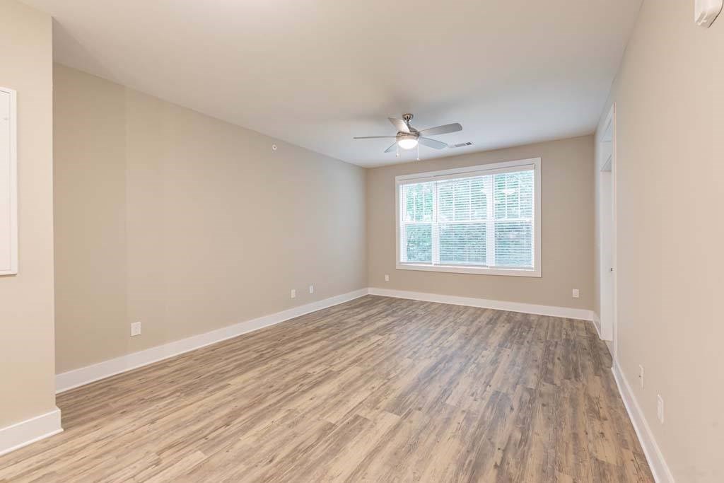 A room with wooden flooring and a ceiling fan at Foxwood Apartments, Raleigh-Durham, 27616