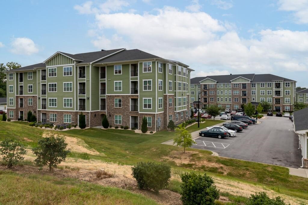 A large apartment complex with a parking lot in front at Foxwood Apartments, Raleigh-Durham, NC, 27616
