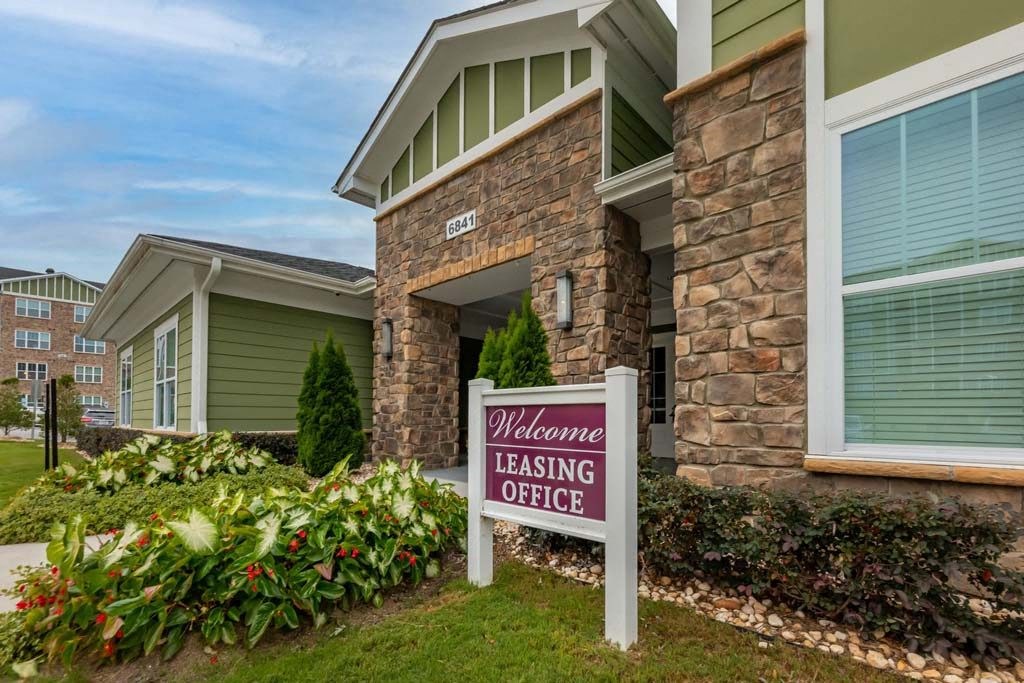 A sign in front of a building that says at Foxwood Apartments, North Carolina