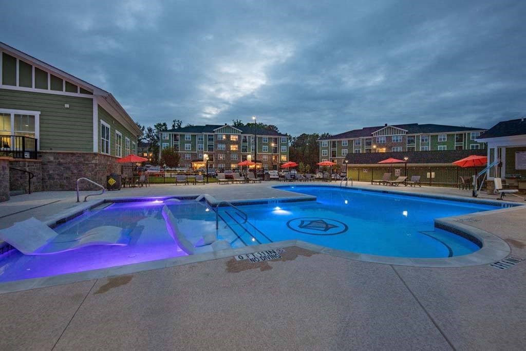 A swimming pool with a blue light in the middle of it at Foxwood Apartments, Raleigh-Durham, 27616