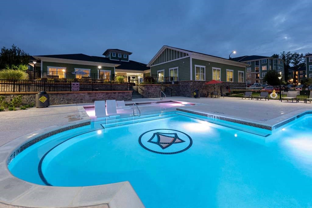 A pool with a diamond logo in the middle of it at Foxwood Apartments, Raleigh-Durham