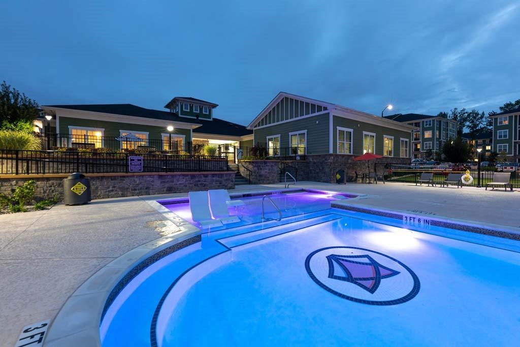 A swimming pool with a logo in the middle of it at Foxwood Apartments, Raleigh-Durham, NC