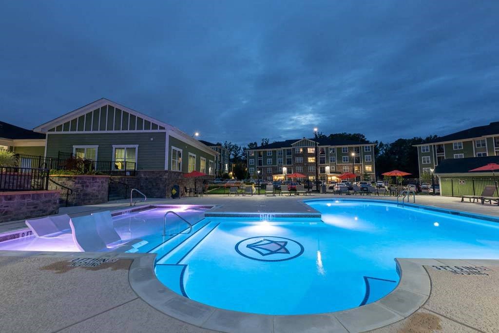 A swimming pool with a logo in the middle of it. at Foxwood Apartments, Raleigh-Durham, NC, 27616