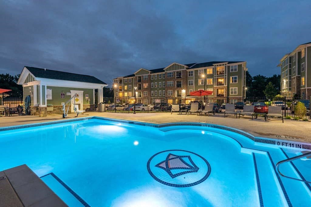 A swimming pool with a diamond logo in the middle of it. at Foxwood Apartments, Raleigh-Durham, NC