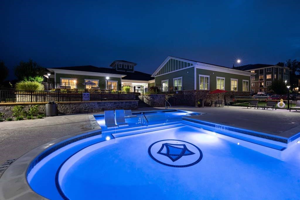 A swimming pool with a diamond logo in the middle of it. at Foxwood Apartments, Raleigh-Durham, 27616