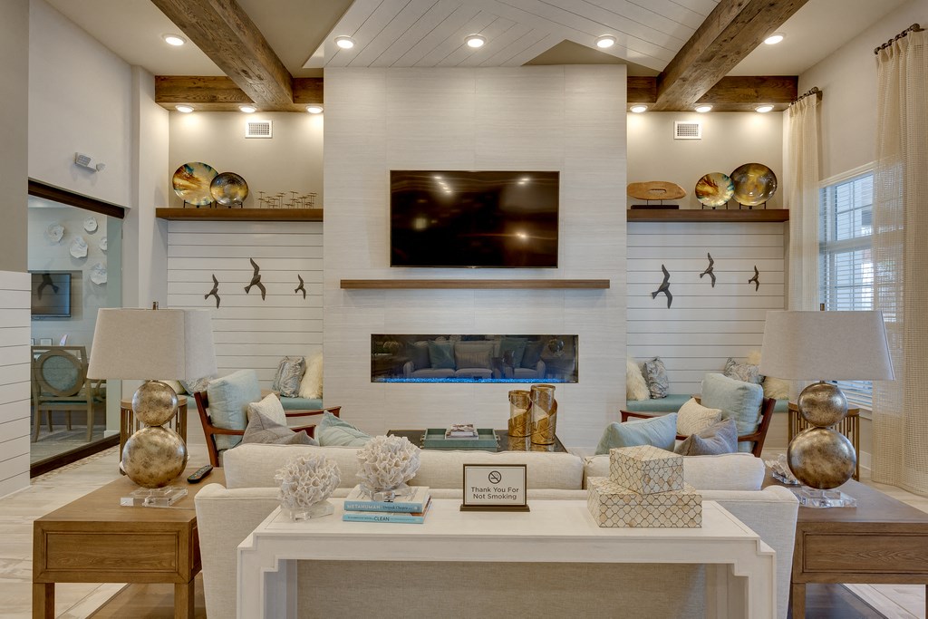 a white living room with a fireplace and a television
