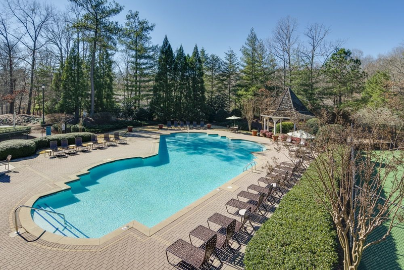 a large swimming pool with chairs around it