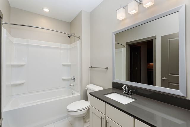 a bathroom with a sink toilet and a mirror
