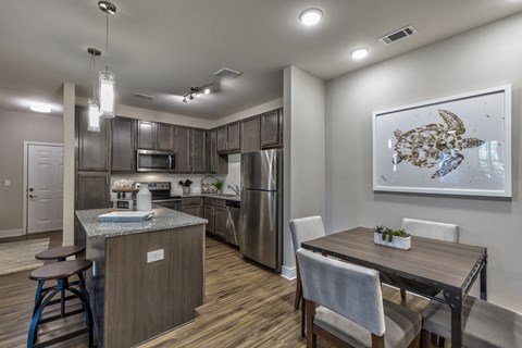 an open kitchen and dining room with a table and chairs