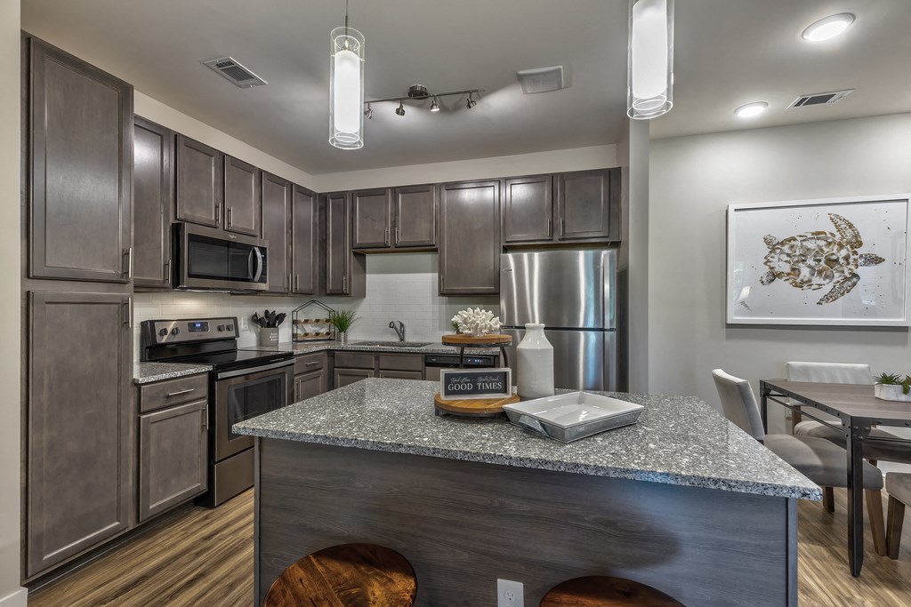 a kitchen with stainless steel appliances and a granite counter top