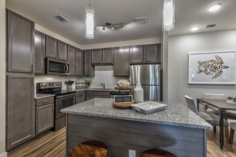 a kitchen with stainless steel appliances and a granite counter top