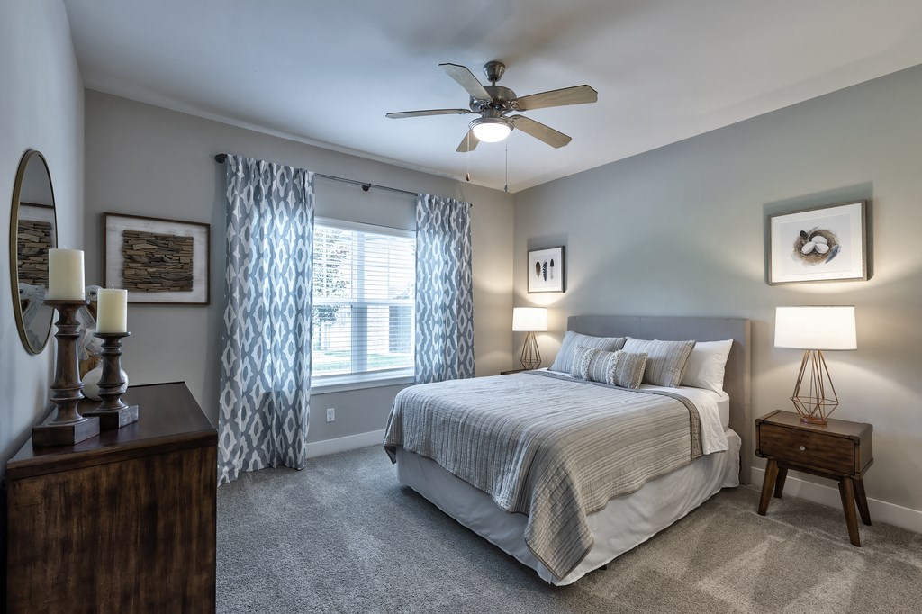 a bedroom with a bed and a ceiling fan