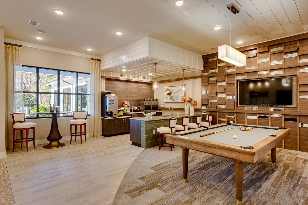 a game room with a pool table and a tv