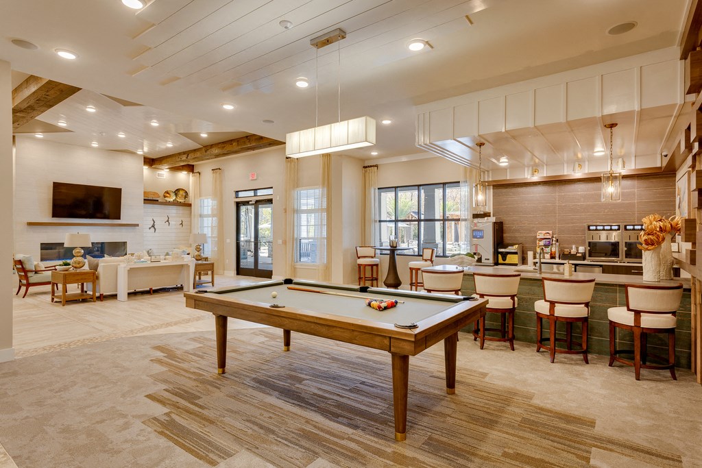 a community room with a pool table and a bar