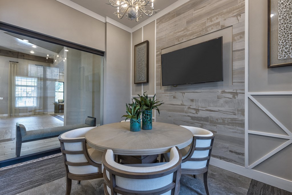a dining room with a table and chairs and a television