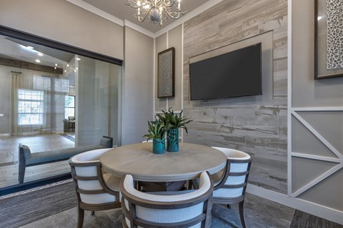 a dining room with a table and chairs and a television