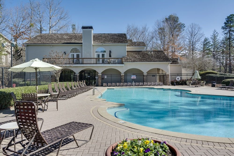 a large swimming pool in front of a resort building