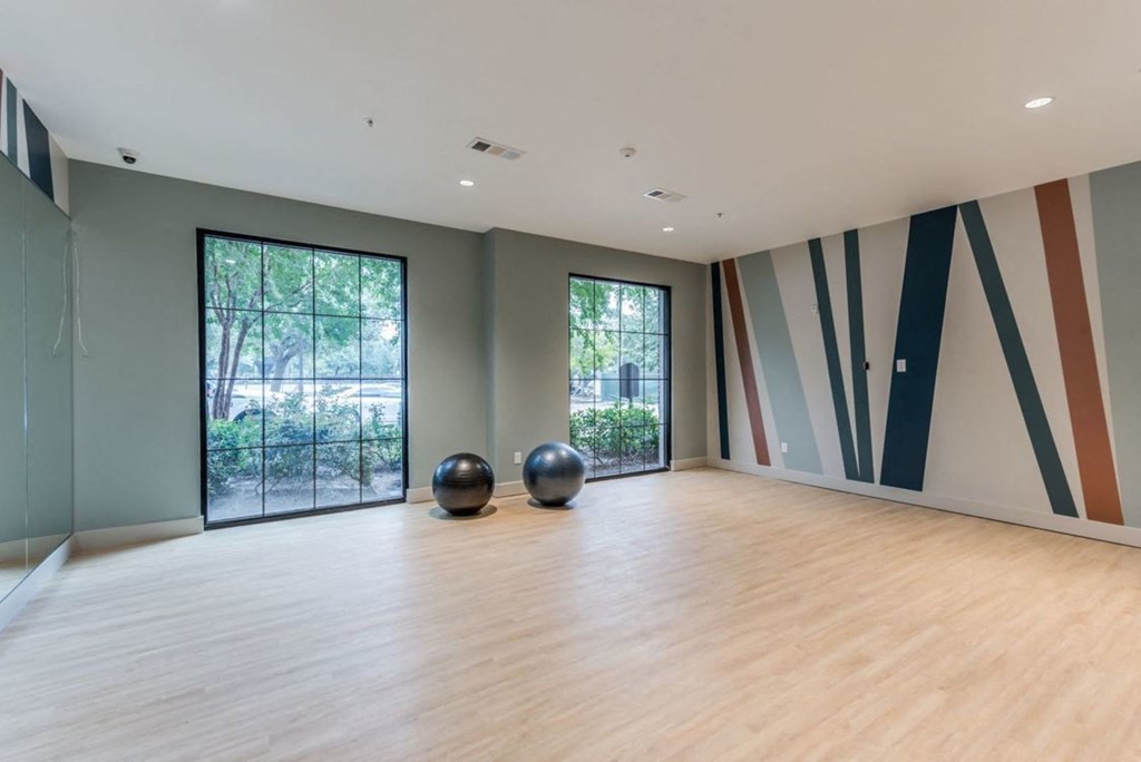 a large room with wood floors and large windows