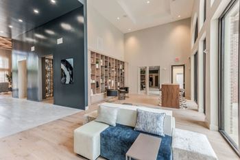 a living room with a couch and a coffee table in front of a large window