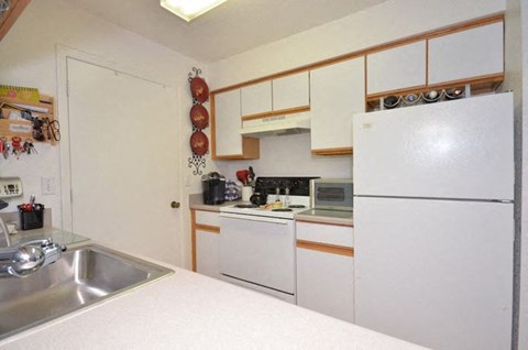 Kitchen With White Appliances at River Park Place Apartments, Vero Beach, Florida