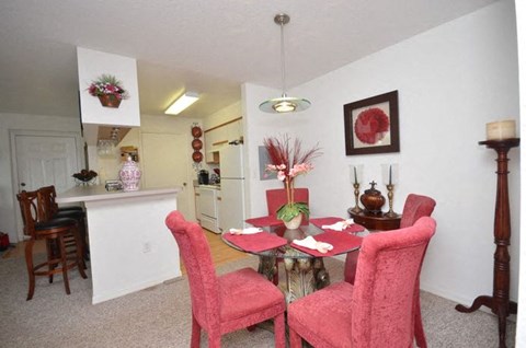 Dinning room with dining table, pink dining chairs, and decor