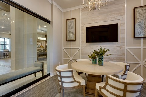 a dining room with a table and chairs and a television