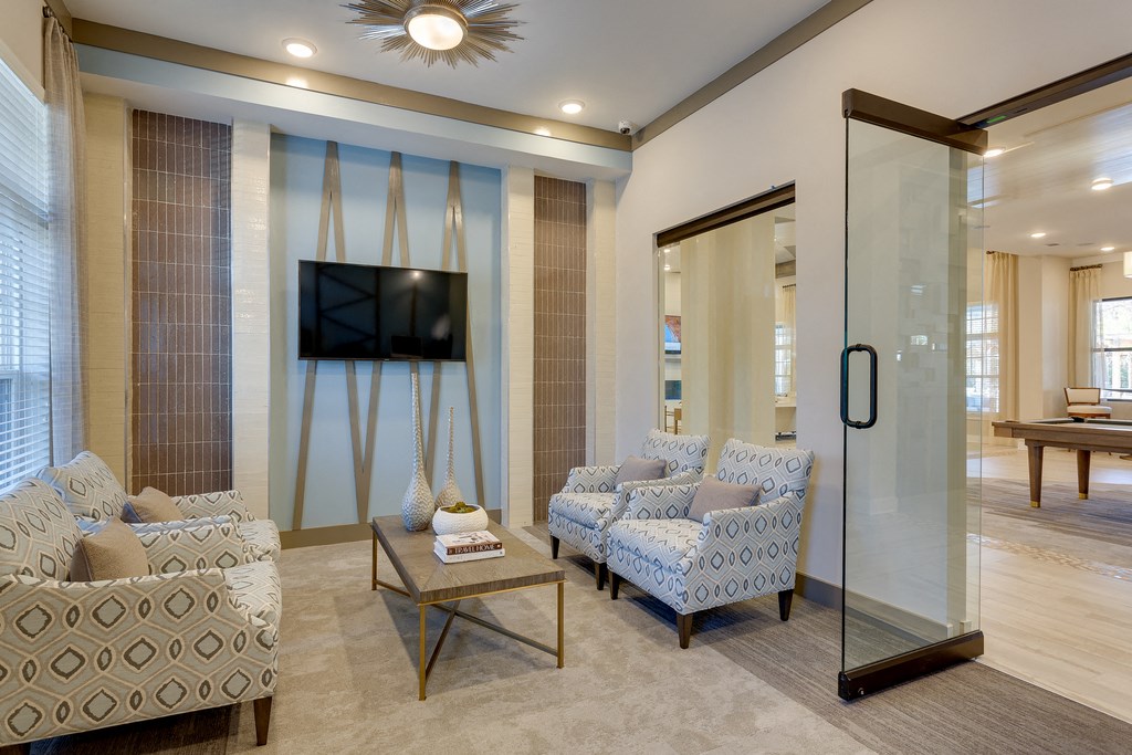 a living room with blue and white furniture and a tv