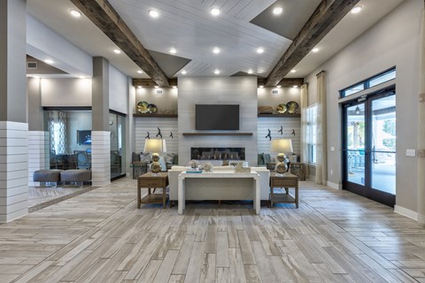 a large living room with a fireplace and a table