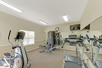 A well-equipped gym with treadmills, exercise bikes, and other fitness machines. at Fox Hollow Apartment Homes, High Point, NC, 27265