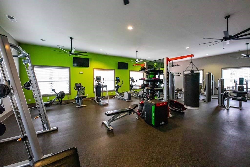 A gym with a variety of equipment including weights and cardio machines at Foxwood Apartments, North Carolina, 27616