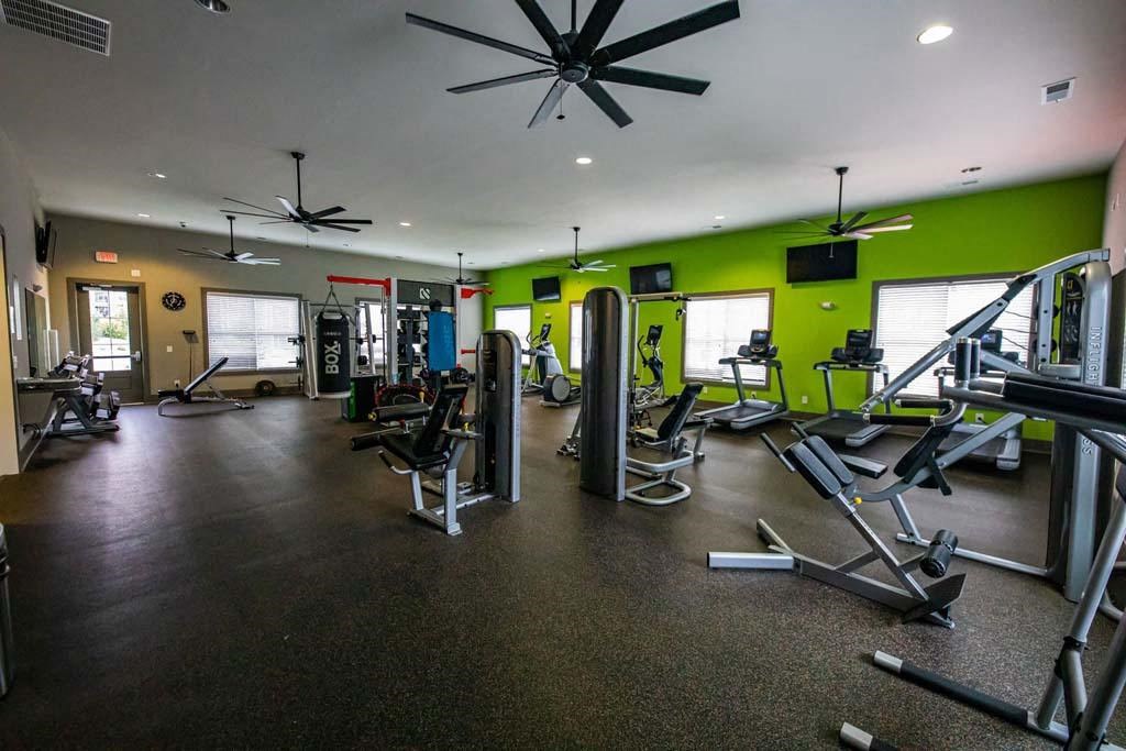 A gym with a variety of equipment including treadmills, weights, and exercise machines. at Foxwood Apartments, Raleigh-Durham, NC