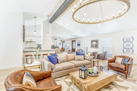 A living room with a brown leather chair and a wooden coffee table.