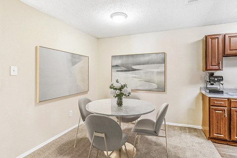 Dining room with a 4 person table and ceiling light above the table.