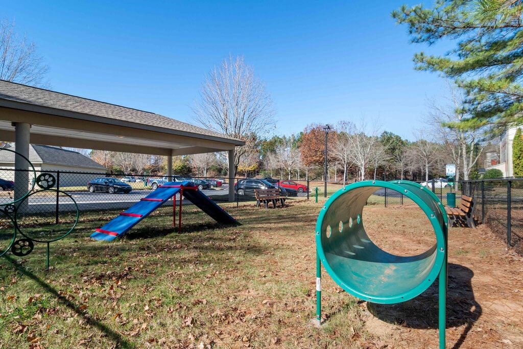a playground with a swing set and a slide