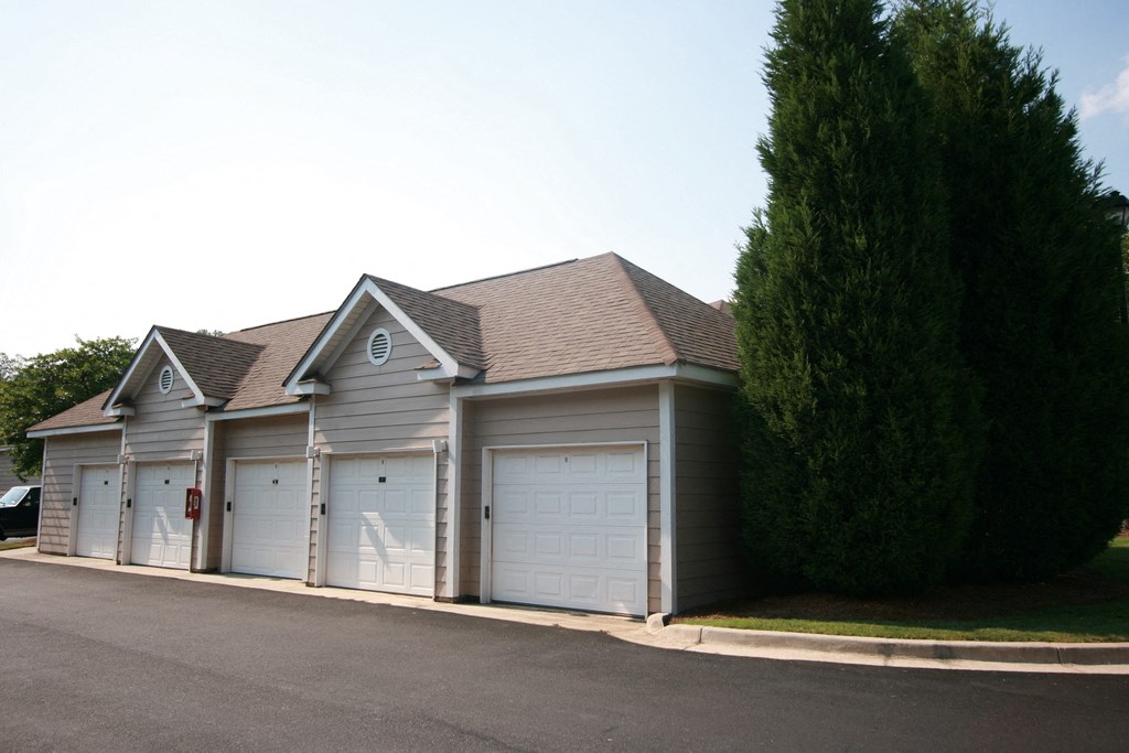 a garage with white doors and a brown roof