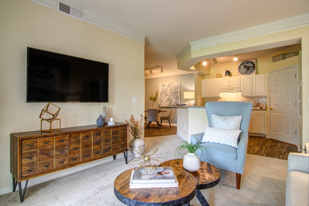 staged living room with view of kitchen in the background