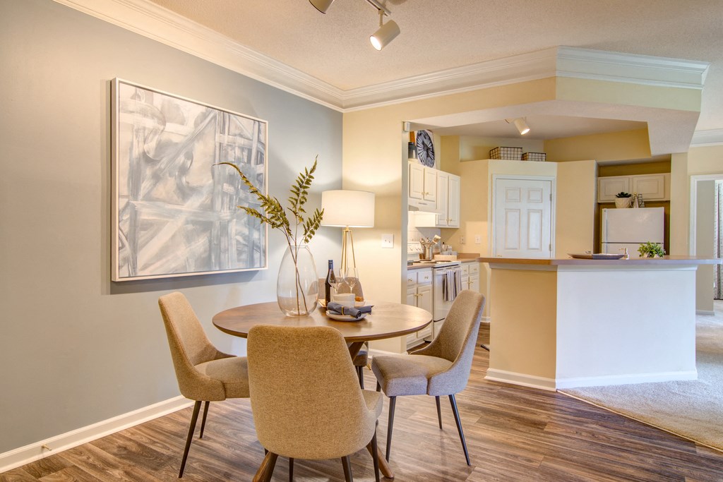 a dining room and kitchen with a table and chairs