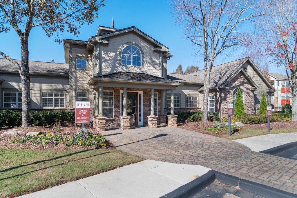 Club House Entrance with long sidewalk surrounded by trees