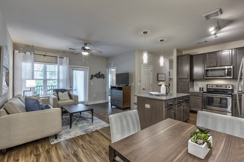 an open living room and kitchen with a table and chairs