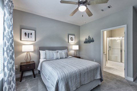 a bedroom with a large bed and a ceiling fan